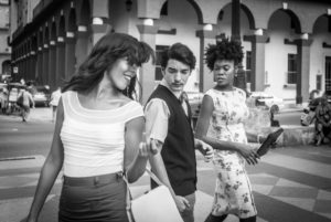 Cuba, Havanna, pretty young woman crosses the street, man looks for her, woman with jealous glance Cuba, Havanna, pretty young woman crosses the street, man looks for her, woman with jealous glance